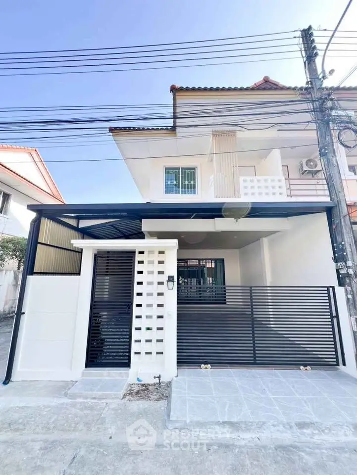 Modern townhouse exterior with gated entrance and sleek design