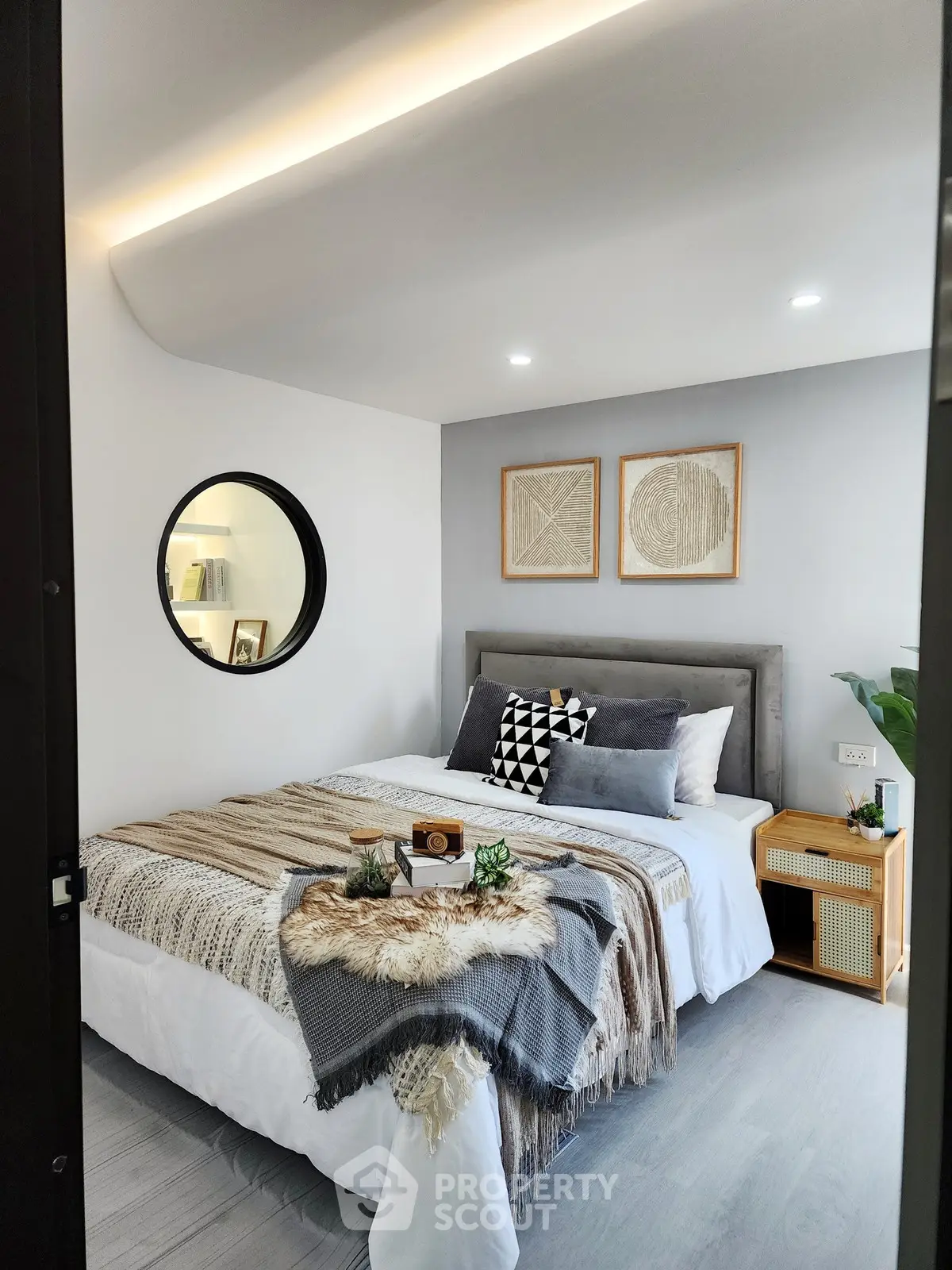 Stylish bedroom with modern decor and cozy ambiance, featuring elegant bedding and unique wall art.
