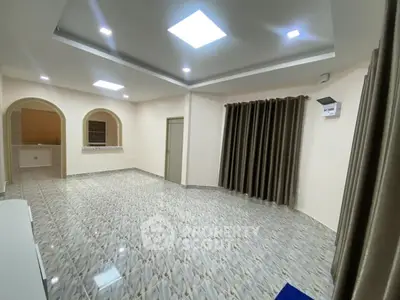 Spacious modern living room with elegant tile flooring and recessed lighting