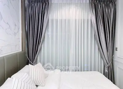 Luxurious bedroom with elegant curtains and plush bedding