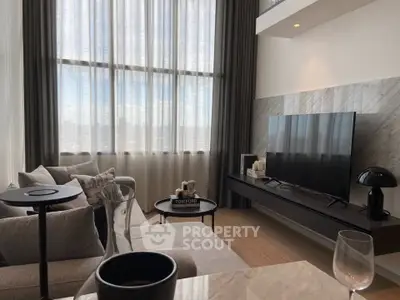 Luxurious modern living room with high ceilings and large windows offering stunning city views.