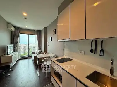 Modern open-layout kitchen with sleek cabinets and stunning city view from the balcony.