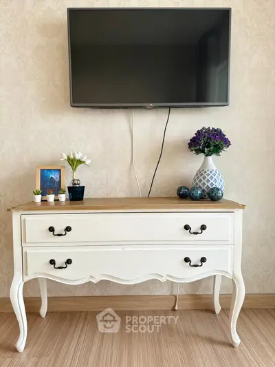Charming living room with elegant vintage dresser and wall-mounted TV, perfect for cozy home decor.