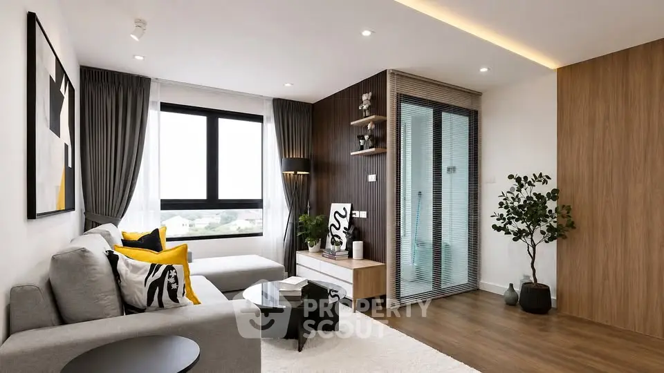 Modern living room with stylish decor and large window offering natural light.