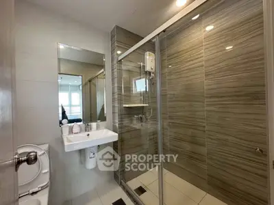 Modern bathroom with sleek shower and elegant fixtures in a contemporary home.