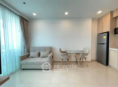 Modern living room with cozy sofa and dining area in open layout apartment
