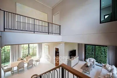 Luxurious open-plan living room with high ceilings and elegant dining area, perfect for entertaining.