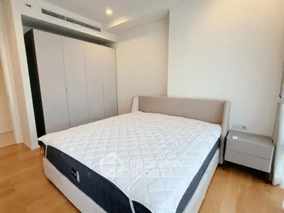 Spacious bedroom with modern design and ample storage in luxury apartment