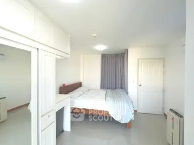 Bright and spacious bedroom with modern furnishings and ample natural light