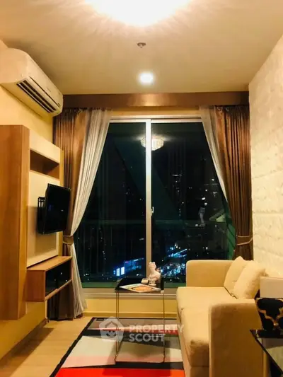Cozy living room with city view, featuring modern decor and large window for natural light.