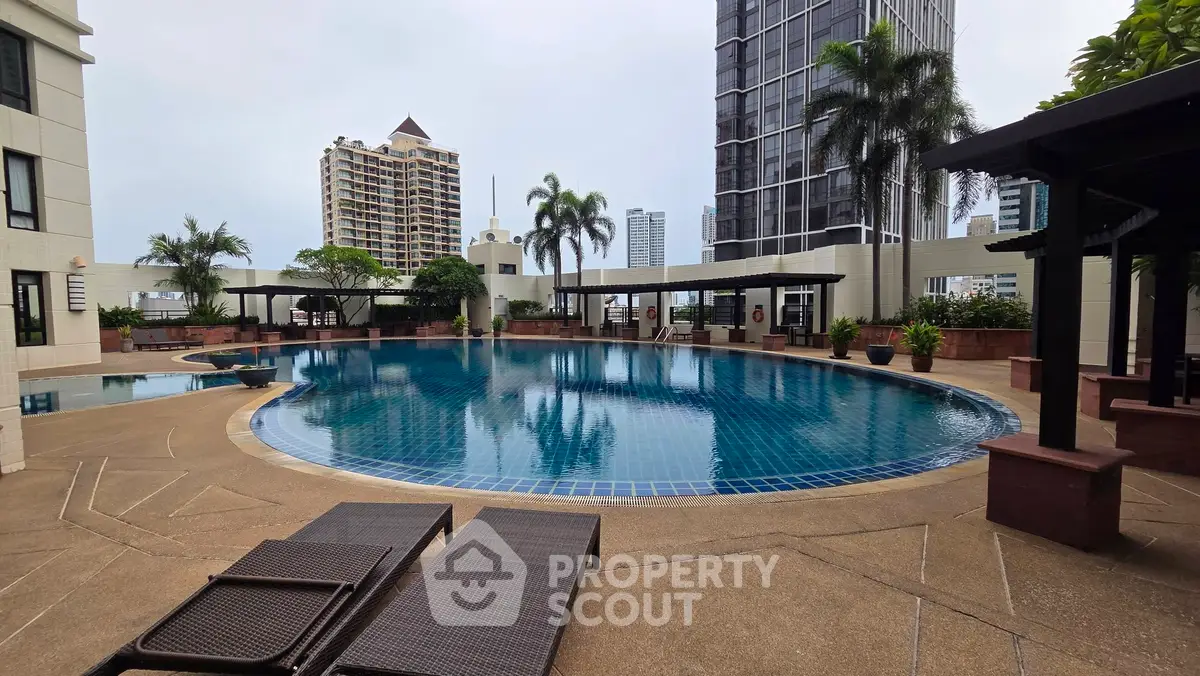 Luxurious high-rise apartment with stunning pool and city views, perfect for urban living.