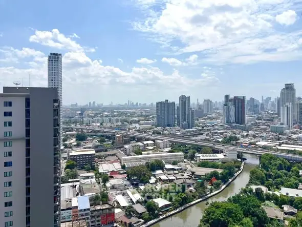 Stunning cityscape view from high-rise building showcasing urban skyline and river.