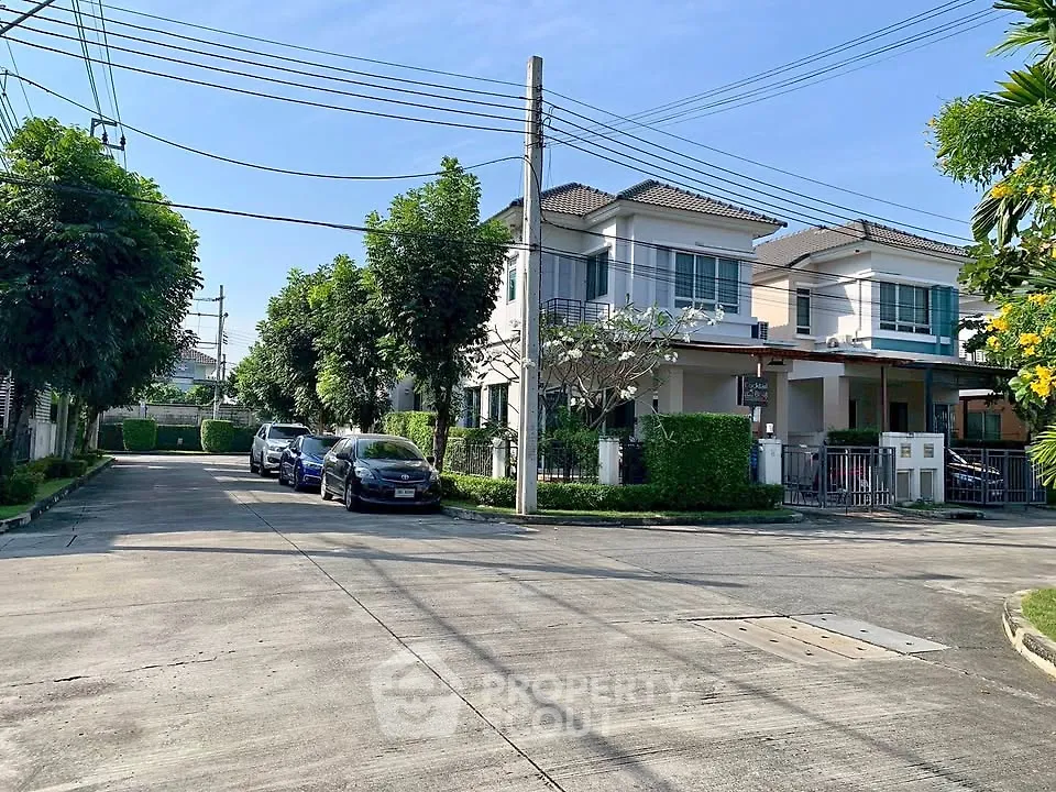 Charming suburban neighborhood with modern two-story homes and lush greenery.