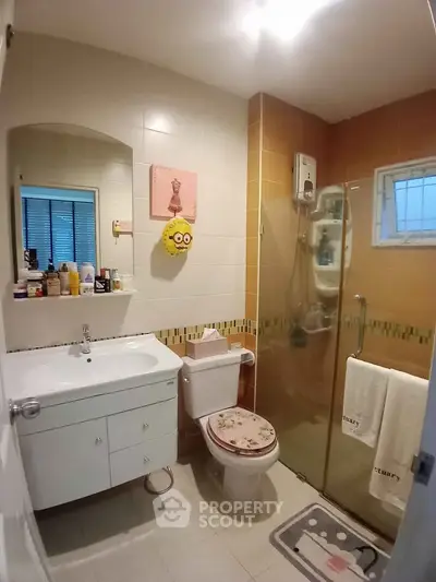 Charming bathroom with modern fixtures and glass shower enclosure