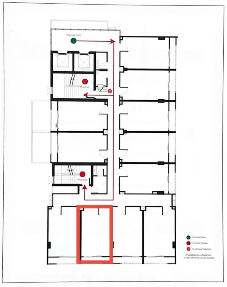 Detailed floor plan showcasing multiple rooms and fire exit routes in a building layout.