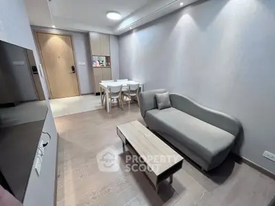 Modern living room with sleek furniture and wooden flooring in a contemporary apartment.