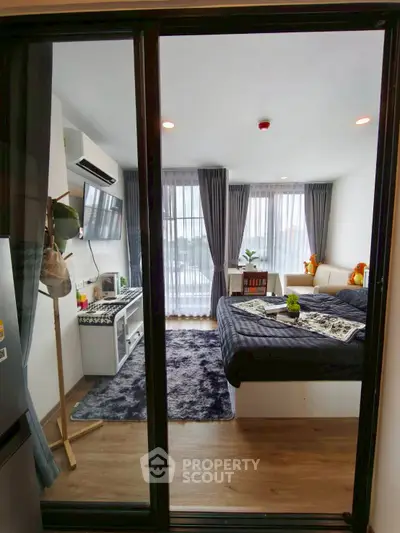 Modern bedroom with large windows and stylish decor, perfect for urban living.