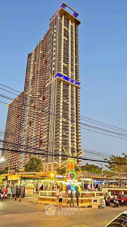 Stunning high-rise building with vibrant street market at dusk, showcasing urban living.