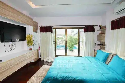 Spacious bedroom with pool view and modern decor