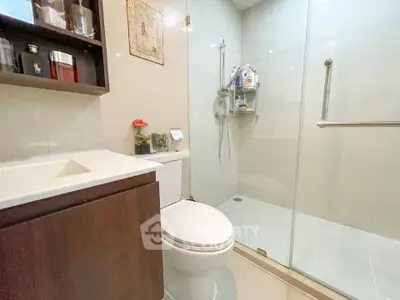 Modern bathroom with glass shower and sleek vanity in elegant home.