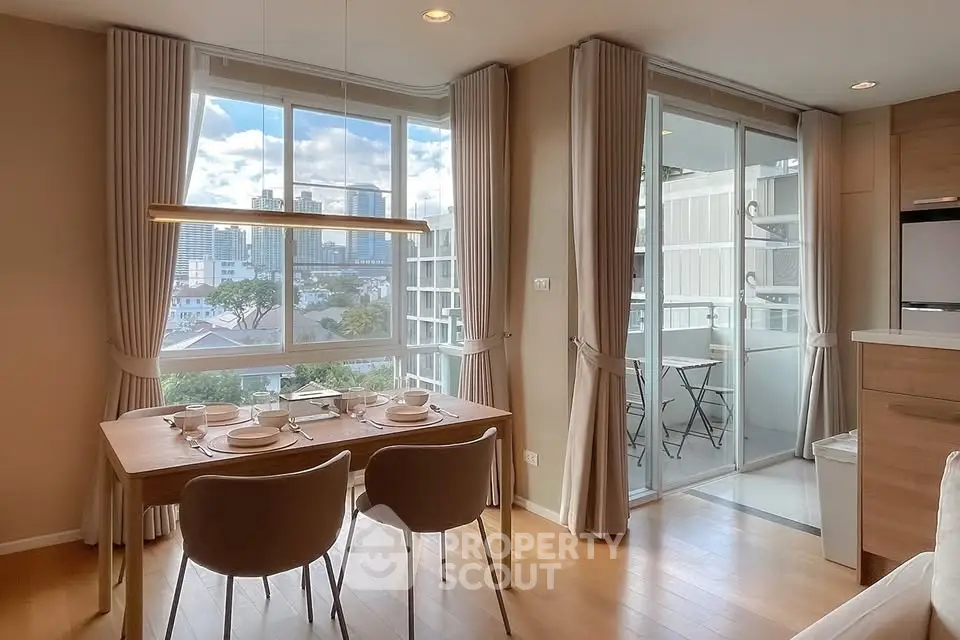 Modern dining area with city view and balcony access in stylish apartment