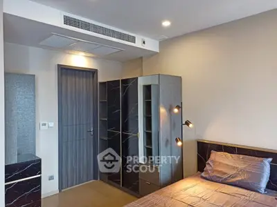 Modern bedroom with sleek design and stylish lighting in a contemporary apartment.