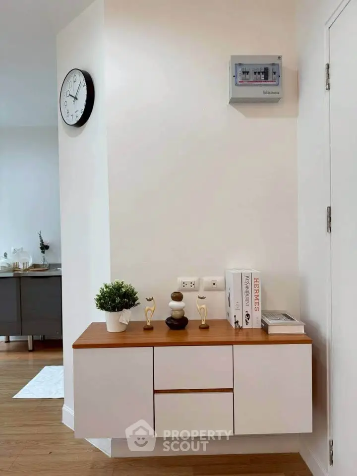 Modern interior with stylish wall-mounted cabinet and decor in a bright room.