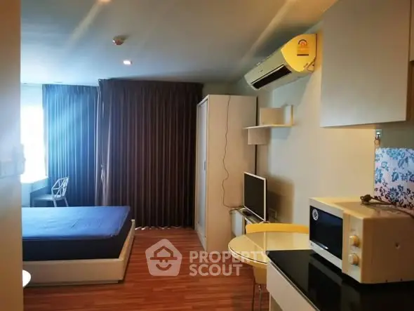 Cozy studio apartment with modern furnishings and wood flooring