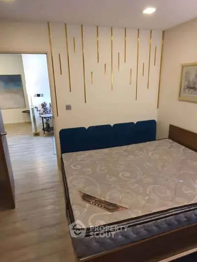 Modern bedroom with stylish decor and comfortable mattress in a well-lit apartment.