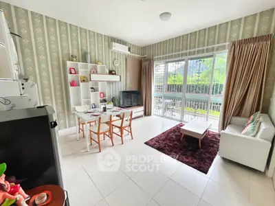 Spacious living room with modern decor and large windows overlooking greenery