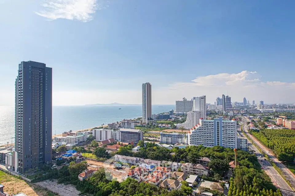 Stunning coastal cityscape with high-rise buildings and ocean view, perfect for luxury real estate investment.