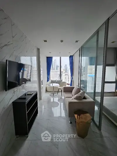 Modern apartment with marble flooring and city view, featuring a cozy living area and glass partition.