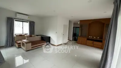 Spacious living room with modern furniture and large windows for natural light.