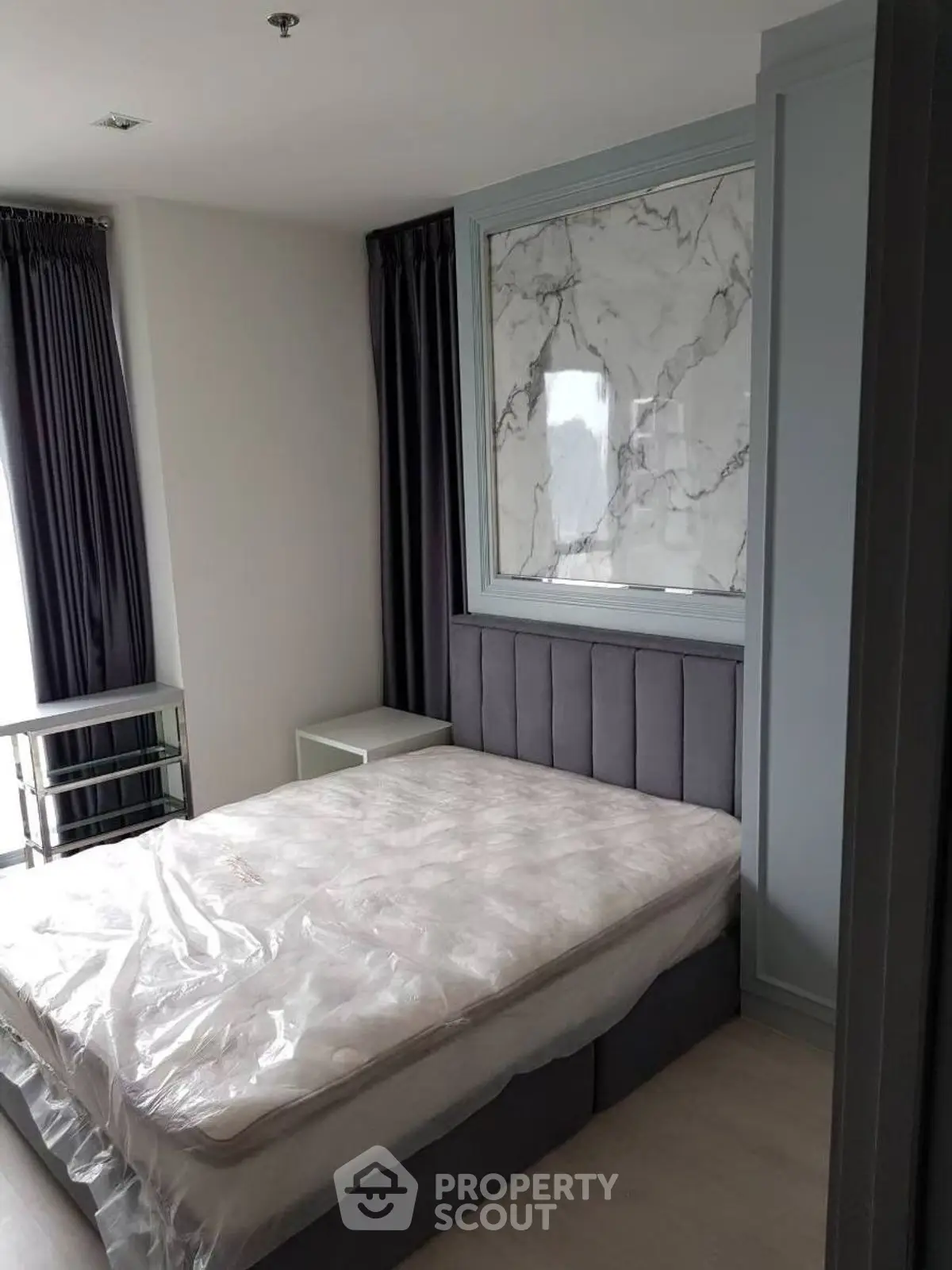 Modern bedroom with elegant marble accent wall and plush bed