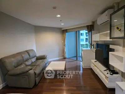 Modern living room with sleek furniture and balcony view in urban apartment