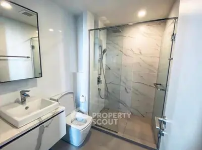 Modern bathroom with glass shower and sleek fixtures
