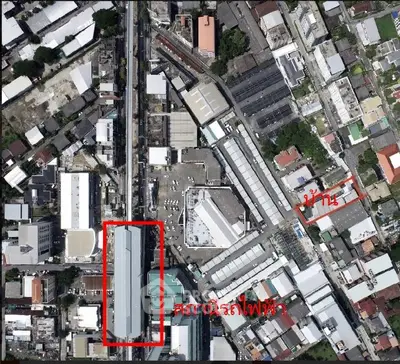 Aerial view of urban area with train station and surrounding buildings.