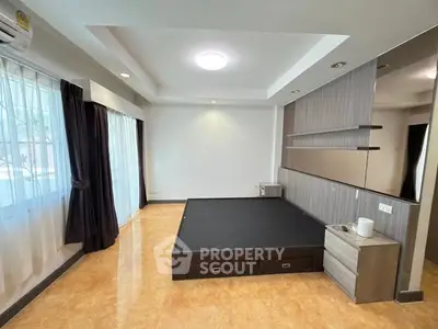 Spacious bedroom with modern design and ample natural light