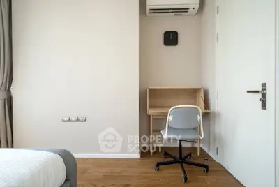 Modern minimalist bedroom with study desk and air conditioning