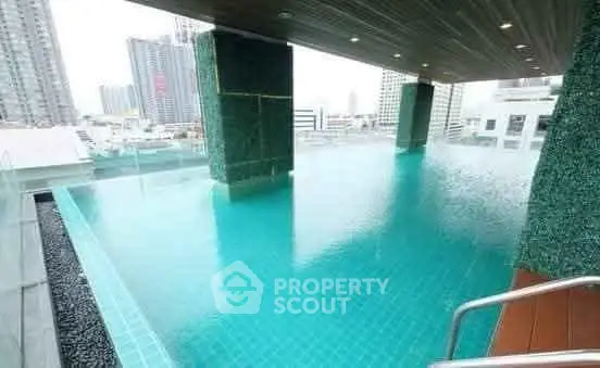 Luxurious rooftop infinity pool with stunning cityscape views in modern high-rise building.