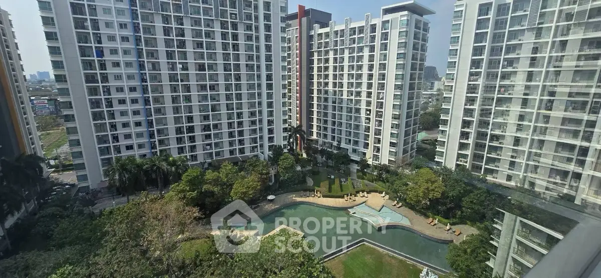 Stunning high-rise apartment complex with lush garden and pool view
