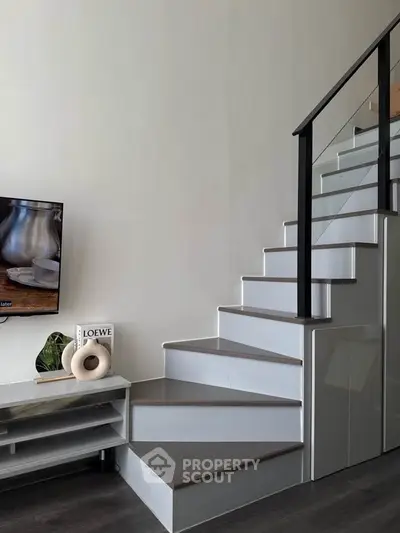 Modern interior with sleek staircase and stylish decor, perfect for contemporary living.