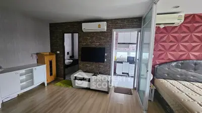 Modern studio apartment with stylish decor and open layout, featuring a cozy living area and sleek kitchen.