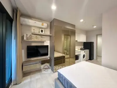 Modern studio apartment with sleek design, featuring a mirrored wardrobe, wall-mounted TV, and in-unit washer.