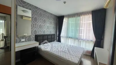 Spacious bedroom with elegant wallpaper and large window for natural light.