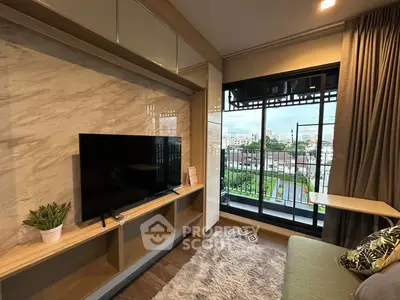 Modern living room with large TV and balcony view in stylish apartment