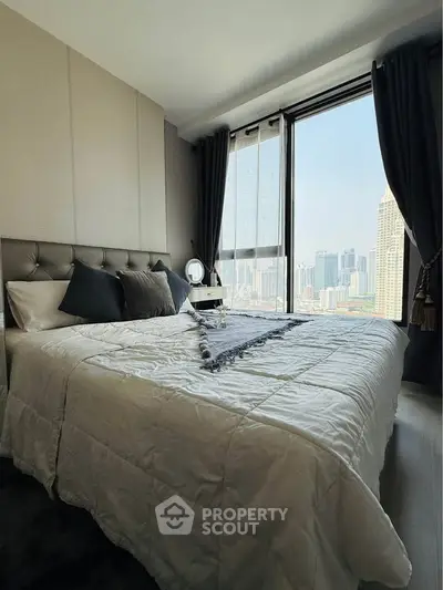 Luxurious bedroom with stunning city view and elegant decor in modern high-rise apartment.