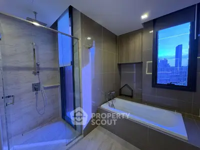 Luxurious modern bathroom with city view, featuring a spacious shower and elegant bathtub.