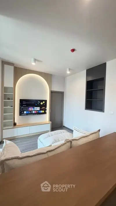 Modern living room with stylish TV setup and cozy seating area