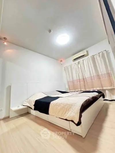 Modern bedroom with stylish bed and air conditioning in a cozy apartment.